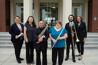musicians standing in front of a building